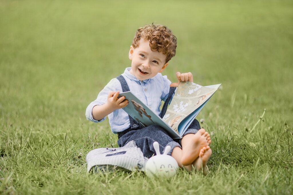 person child book sitting grass 5582976